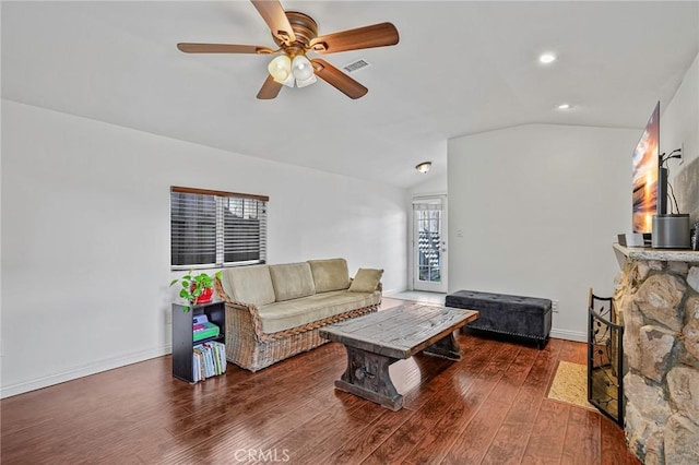 living room with a ceiling fan, wood finished floors, visible vents, baseboards, and lofted ceiling