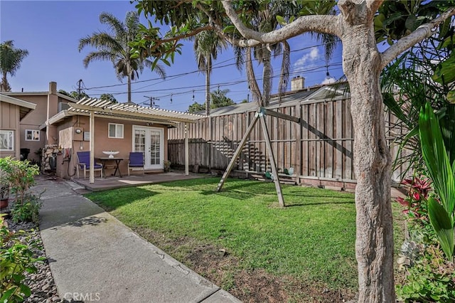 view of yard with french doors, a patio, and a fenced backyard