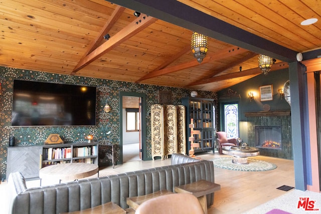 living room featuring wood ceiling, a fireplace, hardwood / wood-style floors, and lofted ceiling with beams