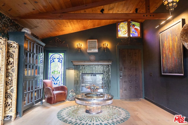 living area with wood ceiling, wood-type flooring, a fireplace, and vaulted ceiling with beams