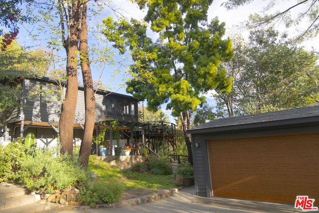 view of home's exterior with a garage and an outdoor structure