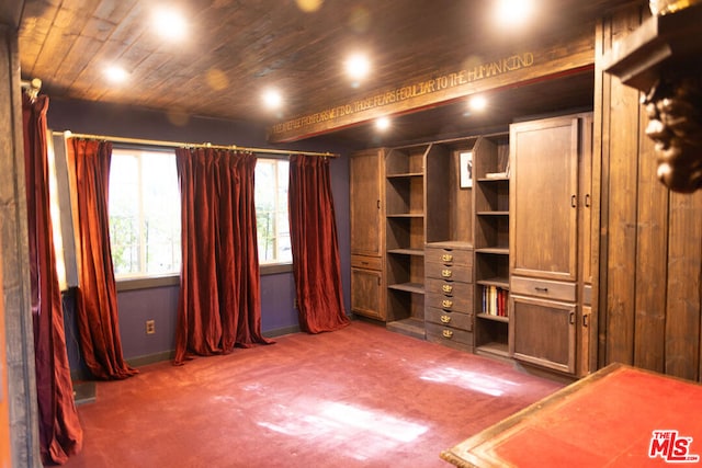 unfurnished bedroom featuring dark carpet and wooden ceiling