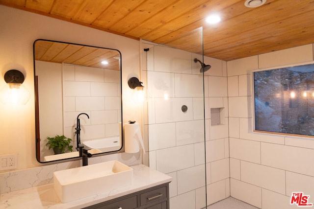 bathroom with vanity, wooden ceiling, and tiled shower