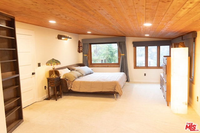 bedroom featuring light carpet and wood ceiling