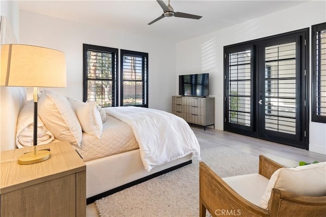 bedroom featuring wood-type flooring, access to outside, and ceiling fan