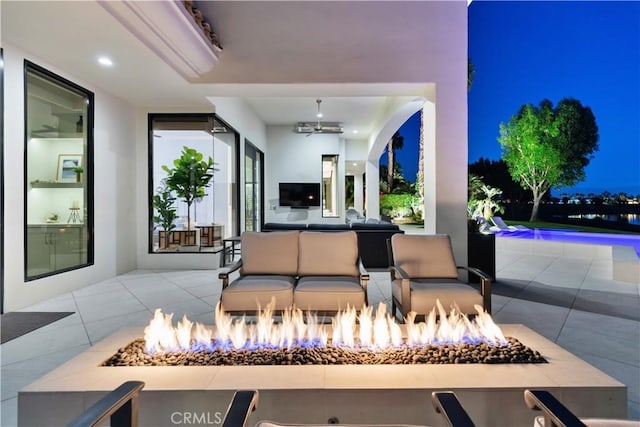 view of patio / terrace featuring an outdoor living space with a fire pit