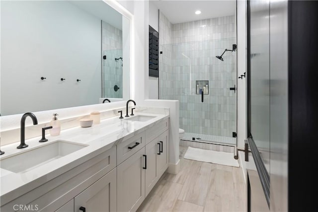 bathroom featuring walk in shower, vanity, and toilet