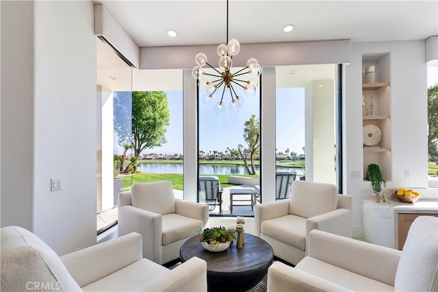 interior space featuring a water view, a chandelier, and built in features