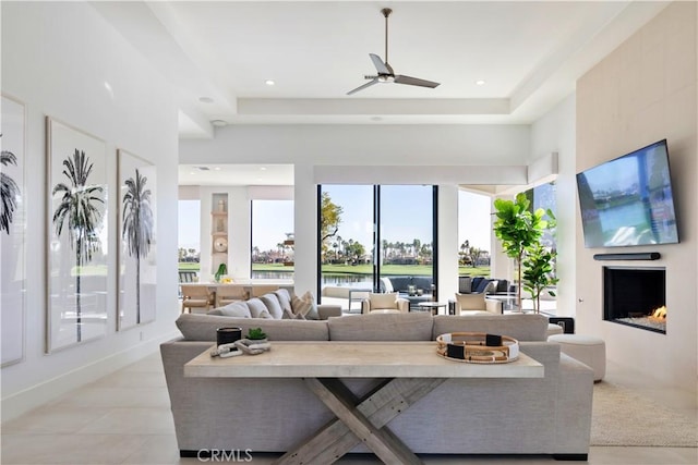 living room with a large fireplace and ceiling fan