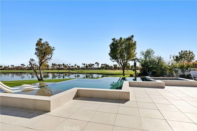 view of swimming pool featuring a patio and a water view