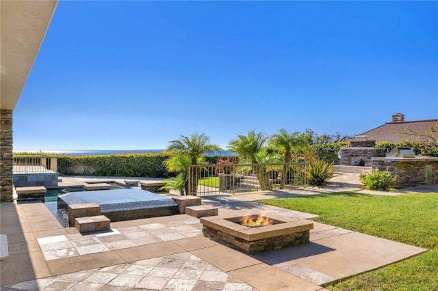 view of patio / terrace featuring an outdoor kitchen and an outdoor fire pit