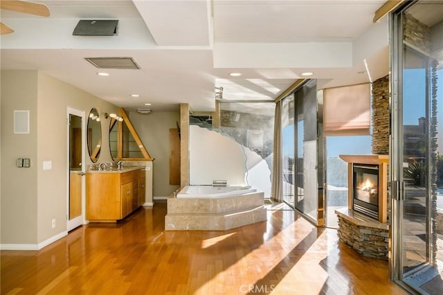 reception featuring a stone fireplace and sink