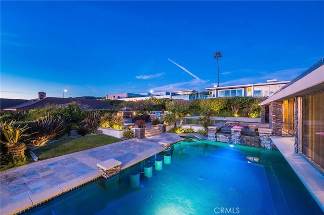 view of pool with a patio and pool water feature