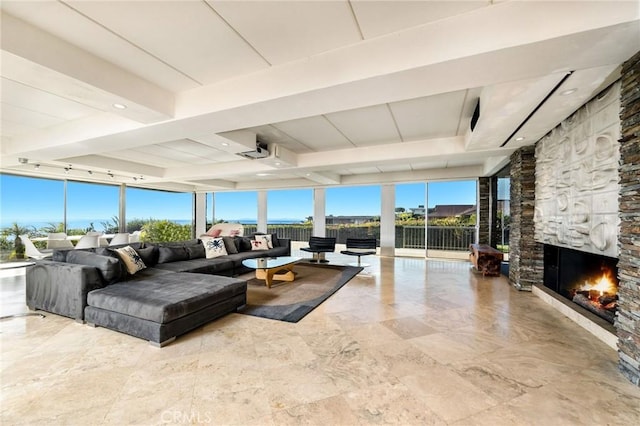 living room with beam ceiling and a fireplace