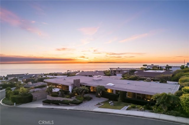 aerial view at dusk with a water view