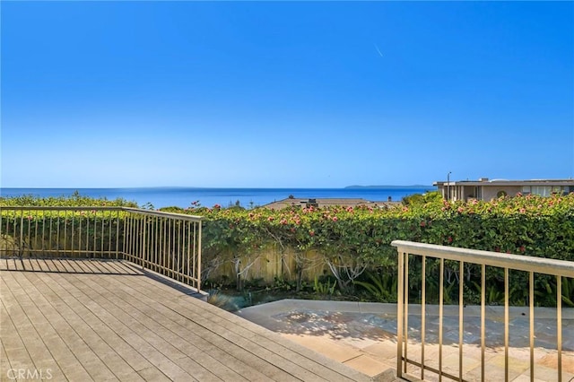 wooden deck featuring a water view