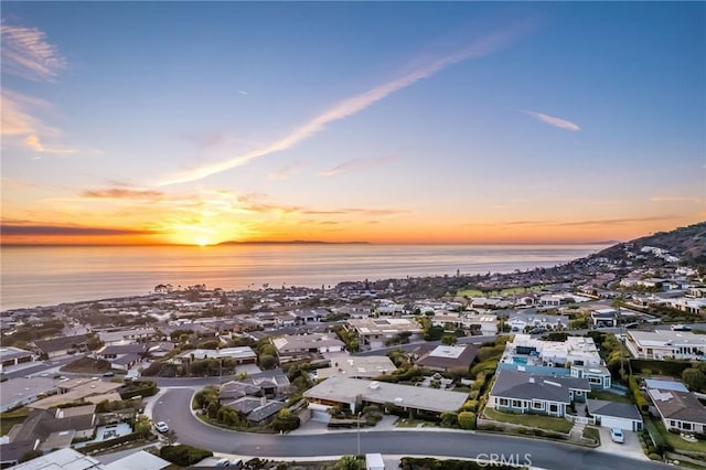 aerial view at dusk with a water view