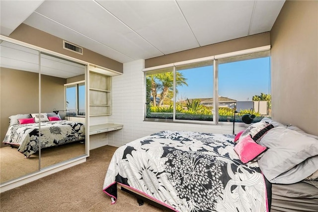 carpeted bedroom with a closet