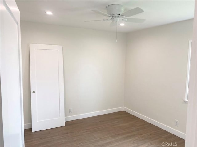 unfurnished room with ceiling fan and dark hardwood / wood-style floors