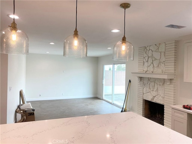 unfurnished living room with a large fireplace and light hardwood / wood-style floors