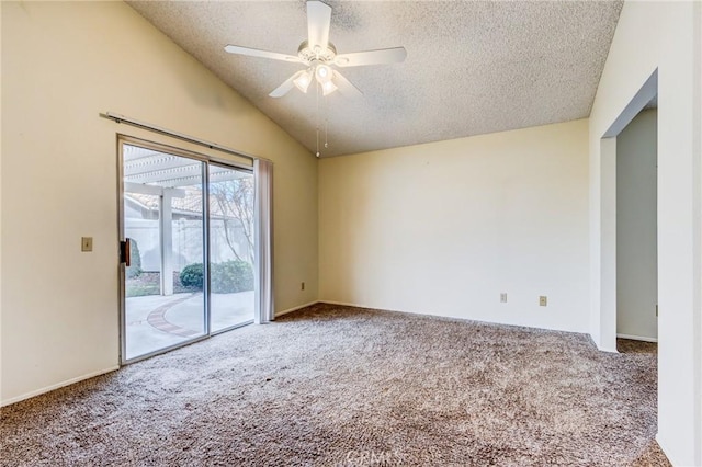 carpeted spare room with ceiling fan, lofted ceiling, and a textured ceiling