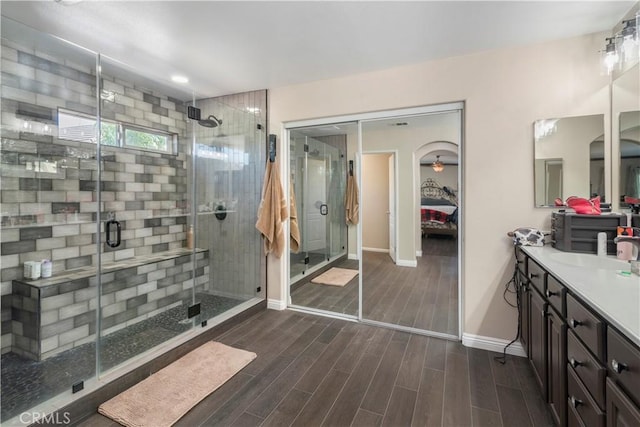 bathroom with vanity and a shower with shower door