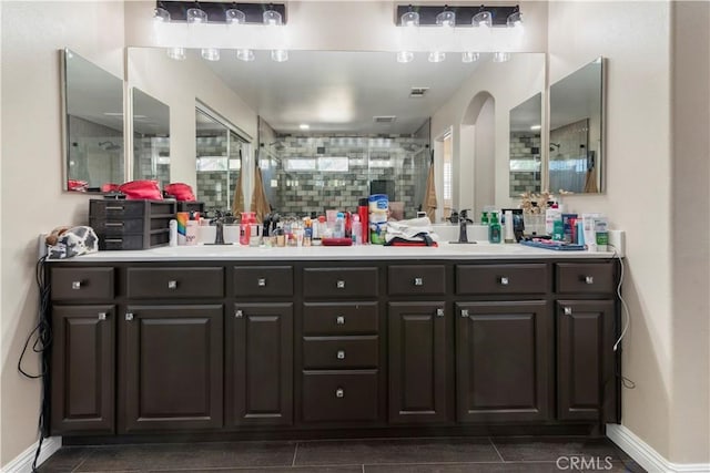 bathroom with vanity, tile patterned floors, and a shower