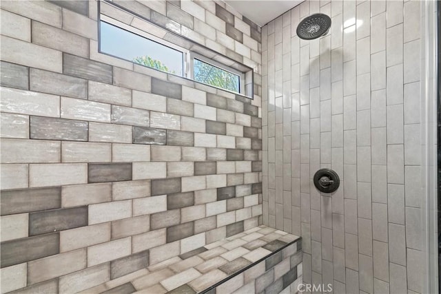 bathroom with a tile shower