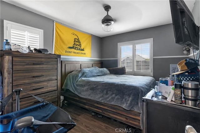 bedroom with dark wood-type flooring and ceiling fan