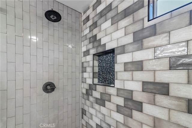 bathroom with tiled shower