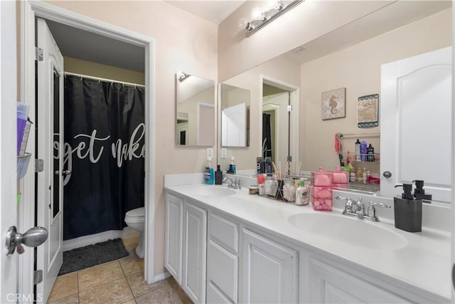 bathroom with vanity, tile patterned floors, and toilet