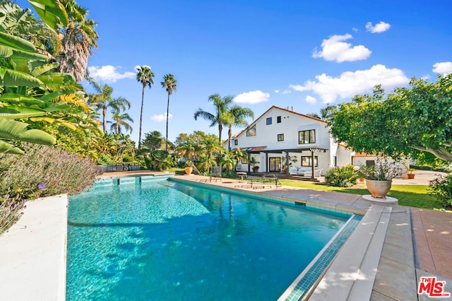 view of swimming pool with a patio area