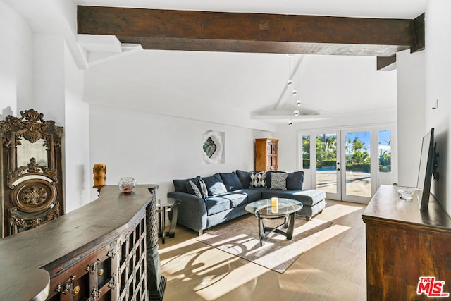 living room featuring vaulted ceiling with beams and french doors