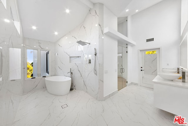 bathroom featuring a high ceiling, plus walk in shower, vanity, and beamed ceiling