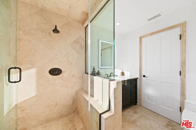 bathroom featuring vanity and a shower with shower door