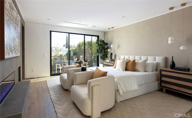 bedroom featuring access to outside and light wood-type flooring