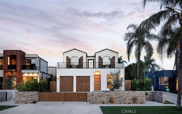 view of front of home featuring a balcony and a garage