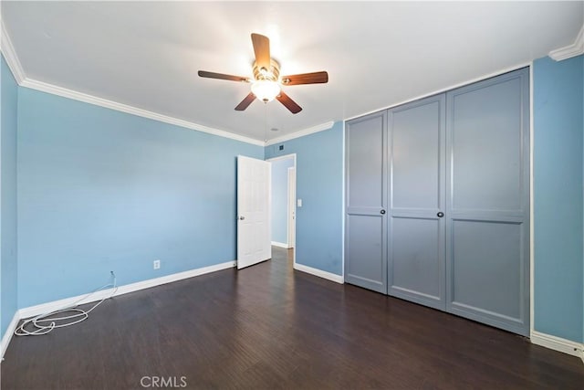 unfurnished bedroom featuring dark hardwood / wood-style flooring, ornamental molding, and ceiling fan