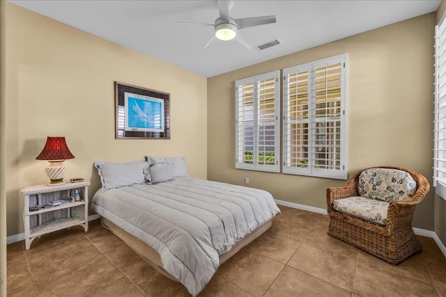 tiled bedroom featuring ceiling fan