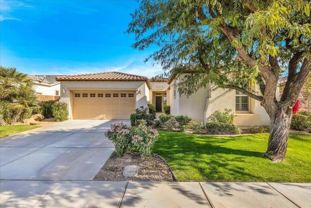 mediterranean / spanish house with a garage and a front yard