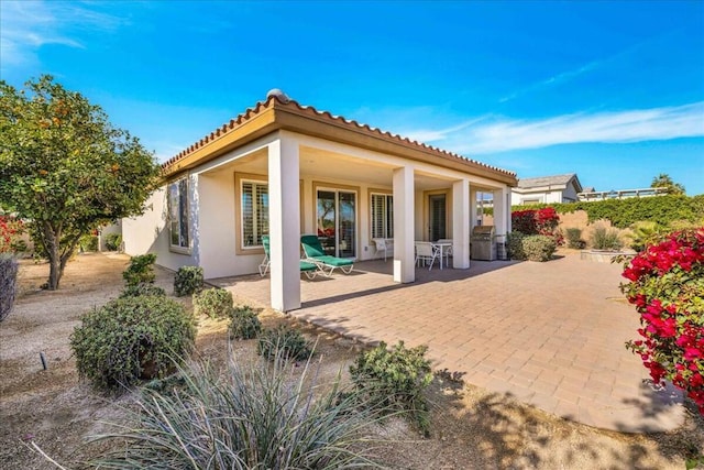 rear view of property with a patio area