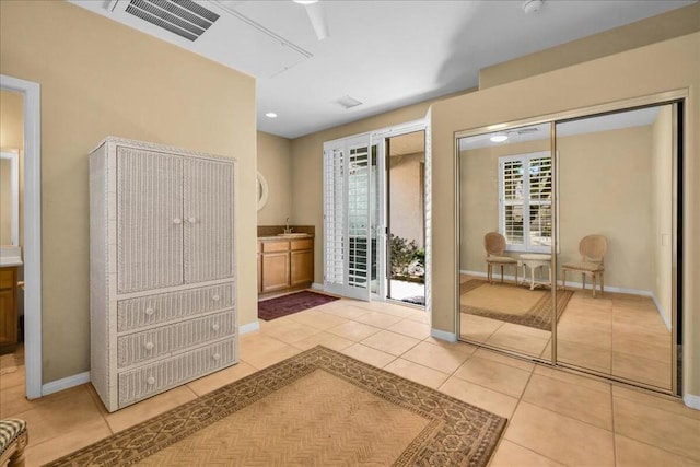 entryway with sink and light tile patterned flooring