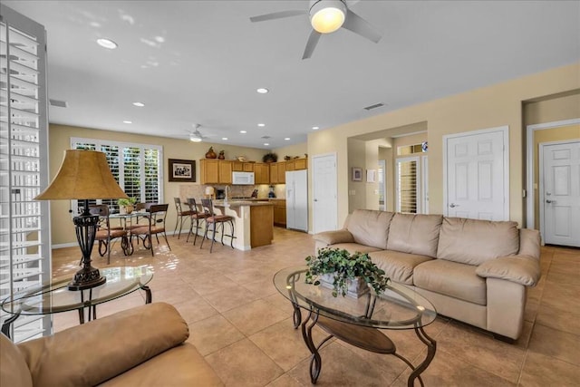 tiled living room featuring ceiling fan