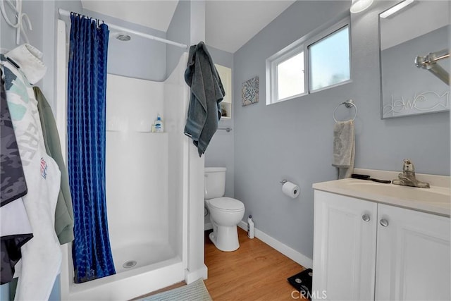 bathroom featuring a shower with curtain, vanity, toilet, and hardwood / wood-style flooring