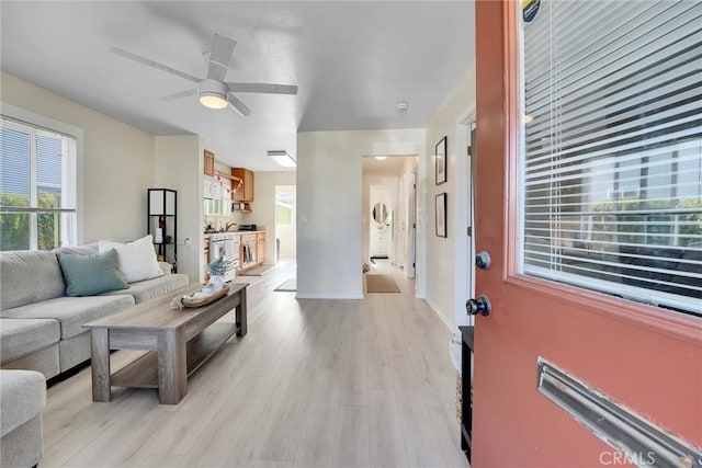 living room with ceiling fan and light wood-type flooring