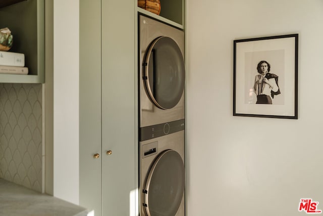 laundry area with stacked washer and clothes dryer