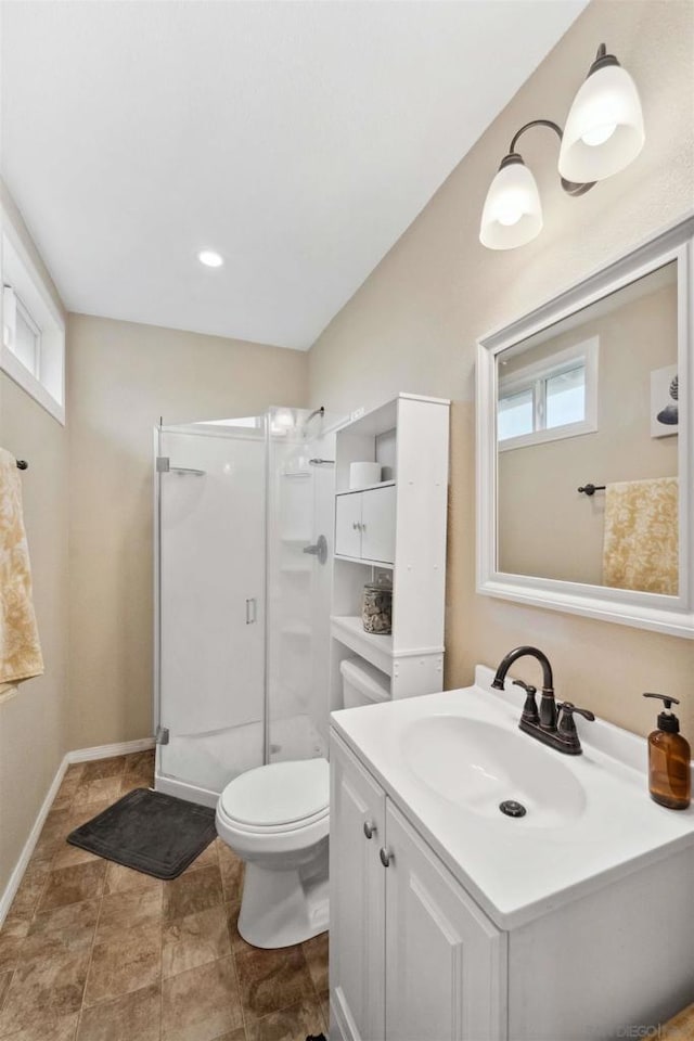 bathroom with a healthy amount of sunlight, toilet, an enclosed shower, and vanity