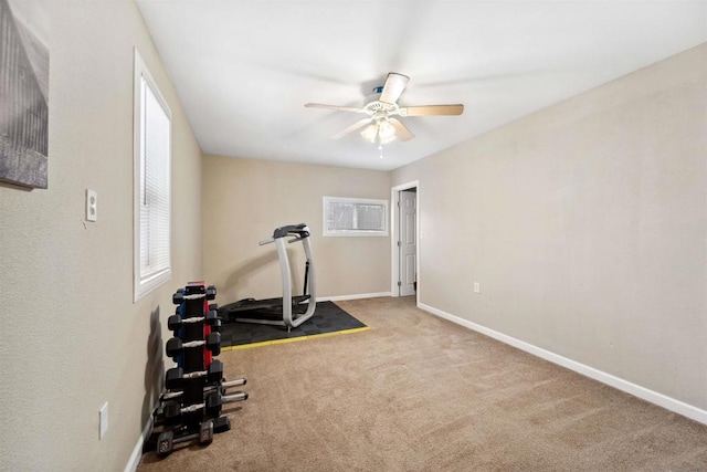 workout room with light colored carpet and ceiling fan