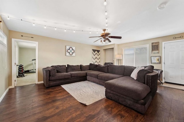 living room with dark wood-type flooring and ceiling fan