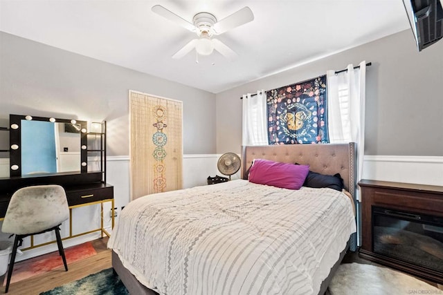 bedroom with ceiling fan and wood-type flooring